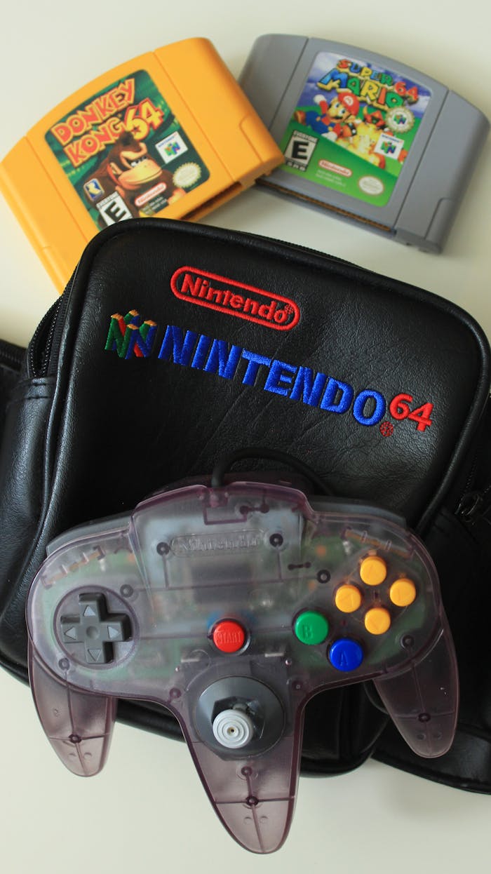 Close-up of a Nintendo 64 set including games, controller, and branded bag.